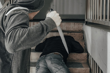 A man with a knife is trying to kill a man on the landing. topics of violence and murder. thief,...