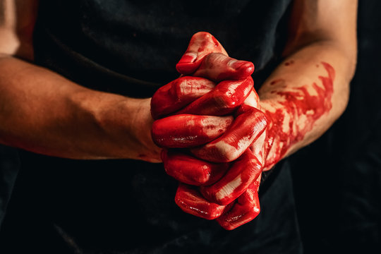 Male hands showing various gestures in the blood on a black background. hands with a gesture of prayer and folded palms