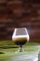 A White Russian is a cocktail made with vodka, coffee liqueur and cream served with ice in an Old Fashioned glass. Often milk or half and half will be used as an alternative to cream..
