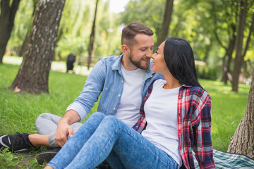 couple in love are resting in the park and hugging