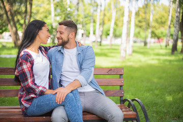 couple in love are resting in the park and hugging