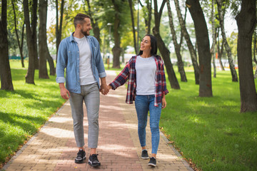 loving couple walking in the park and hugging, beautiful guy and girl