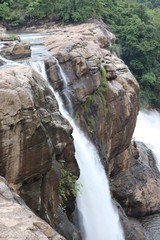 water falling between rocks from waterfalls