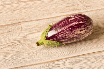 Fresh purple eggplant on wooden table. Natural food.