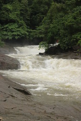water falling between rocks from waterfalls