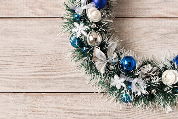 Beautiful Christmas wreath on wooden background. The concept of Christmas
