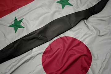 waving colorful flag of japan and national flag of syria.