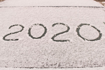 Fototapeta premium The inscription 2020 on the snow. The inscription on the glass of the car. The concept of a New year.