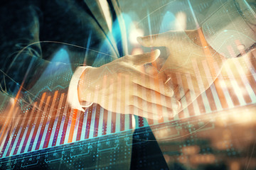 Double exposure of financial chart on cityscape background with two businessmen handshake. Concept of financial analysis and investment opportunities