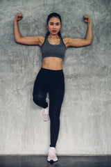 Portrait of beautiful asian young woman wearing  sportswear posing in gym