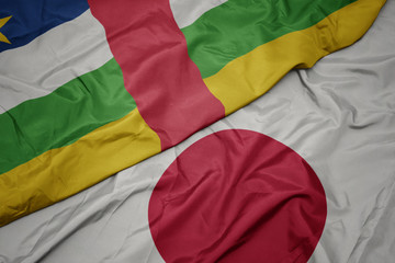 waving colorful flag of japan and national flag of central african republic.