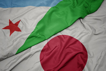 Obraz premium waving colorful flag of japan and national flag of djibouti.
