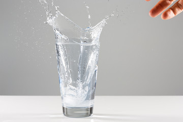 Beautiful splash of water in a glass with ice