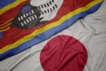 waving colorful flag of japan and national flag of swaziland.