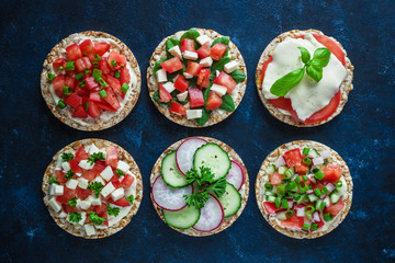 various healthy sandwiches with rice cake chopped tomatoes radish cucumber basil cheese green onion...