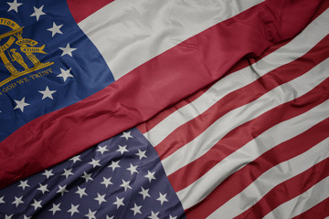 waving colorful flag of united states of america and flag of georgia state. - obrazy, fototapety, plakaty