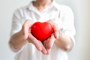 Asian woman holding a red heart