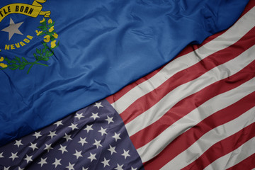 Obraz premium waving colorful flag of united states of america and flag of nevada state.