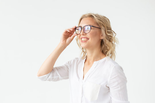 Vision, Optics And Beauty - Young Blond Woman Putting On A Pair Of Glasses On White Background