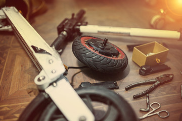 repair of an electric scooter in a workshop. Short circuit wheel motor. © velimir