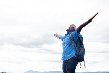 Freedom African tourist  traveler man with backpack on view of mountain background