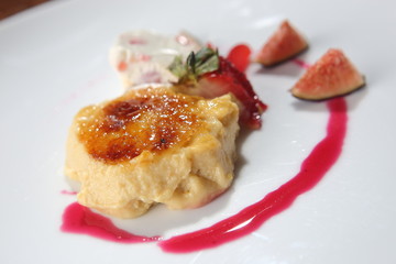 Fig dessert with vanilla ice cream and strawberries.