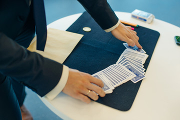 magicians man playing cards in focus
