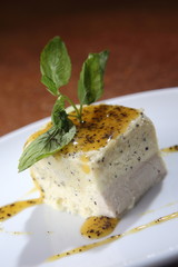 Vanilla dessert bathed in sweet mango and chocolate sauce.