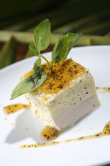 Vanilla dessert bathed in sweet mango and chocolate sauce.
