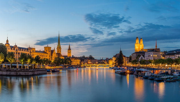 Zurich downtown skyline with Fraumunster and Grossmunster churches at lake zurich at night, Switzerland.