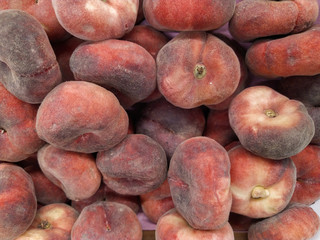 fig peach. saturn peaches. flat peaches harvest. many peaches. Fresh fruit at farmers' market: peaches. fig peach background