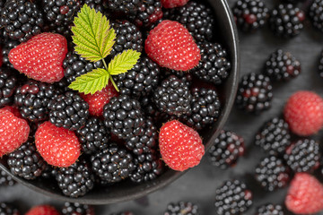 Background from fresh organic blackberries and raspberries, close up. Top view blackberry and raspberry
