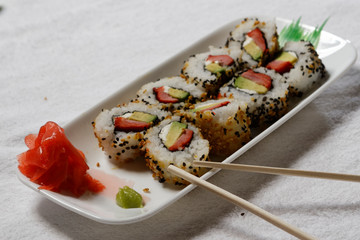 Sushi is traditionally made with medium-grain white rice. It is very often prepared with seafood, such as squid, eel, yellowtail, salmon, tuna or imitation crab meat.
