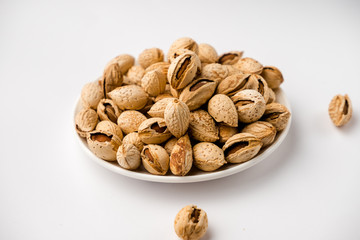tasty nutritious shell almonds on a white background
