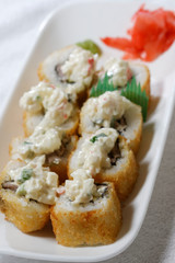 Sushi is traditionally made with medium-grain white rice. It is very often prepared with seafood, such as squid, eel, yellowtail, salmon, tuna or imitation crab meat.