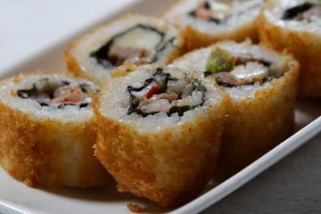 Sushi is traditionally made with medium-grain white rice. It is very often prepared with seafood, such as squid, eel, yellowtail, salmon, tuna or imitation crab meat.