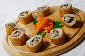Sushi is traditionally made with medium-grain white rice. It is very often prepared with seafood, such as squid, eel, yellowtail, salmon, tuna or imitation crab meat.