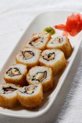 Sushi is traditionally made with medium-grain white rice. It is very often prepared with seafood, such as squid, eel, yellowtail, salmon, tuna or imitation crab meat.