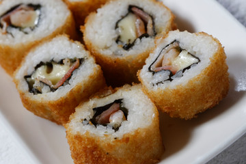 Sushi is traditionally made with medium-grain white rice. It is very often prepared with seafood, such as squid, eel, yellowtail, salmon, tuna or imitation crab meat.