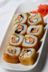 Sushi is traditionally made with medium-grain white rice. It is very often prepared with seafood, such as squid, eel, yellowtail, salmon, tuna or imitation crab meat.