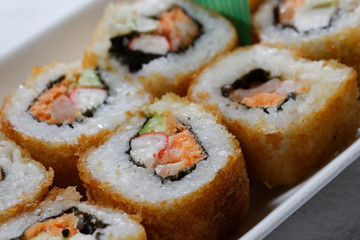 Sushi is traditionally made with medium-grain white rice. It is very often prepared with seafood, such as squid, eel, yellowtail, salmon, tuna or imitation crab meat.