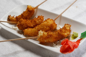 Sushi is traditionally made with medium-grain white rice. It is very often prepared with seafood, such as squid, eel, yellowtail, salmon, tuna or imitation crab meat.