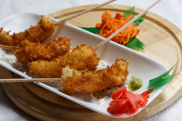 Sushi is traditionally made with medium-grain white rice. It is very often prepared with seafood, such as squid, eel, yellowtail, salmon, tuna or imitation crab meat.