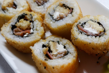 Sushi is traditionally made with medium-grain white rice. It is very often prepared with seafood, such as squid, eel, yellowtail, salmon, tuna or imitation crab meat.