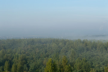 Fog over small town and forest hills in Silesia, Poland, Europe
