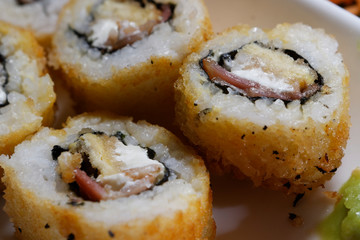 Sushi is traditionally made with medium-grain white rice. It is very often prepared with seafood, such as squid, eel, yellowtail, salmon, tuna or imitation crab meat.
