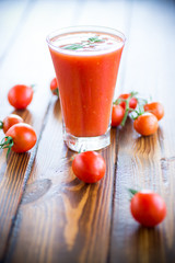 homemade tomato juice in a glass and fresh tomatoes