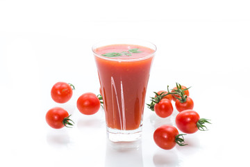 homemade tomato juice in a glass and fresh tomatoes