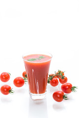homemade tomato juice in a glass and fresh tomatoes