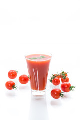homemade tomato juice in a glass and fresh tomatoes